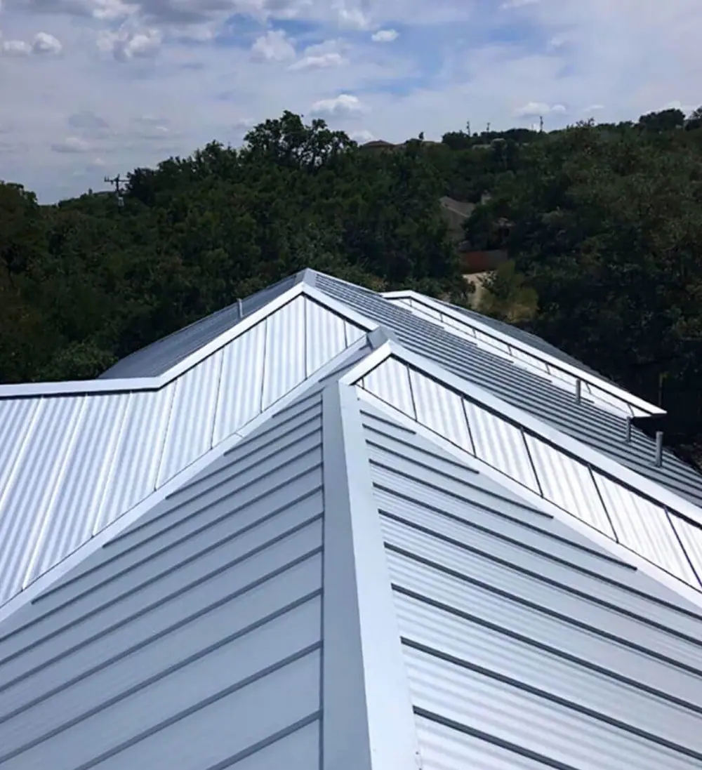A new standing seam metal roof above the trees in San Antonio