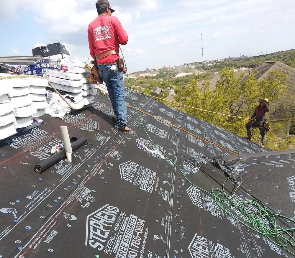 A Stephens roofer on a roof deck laid with underlayment